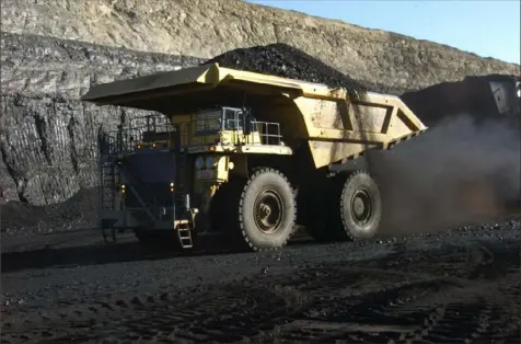  ?? Matthew Brown/Associated Press ?? A haul truck with a 250-ton capacity carries coal from the Spring Creek strip mine near Decker, Mont., in 2016. The response from fossil fuel companies to the long-awaited United Nations-backed report on climate change is showing deep fissures within the industry on how to combat the global threat.