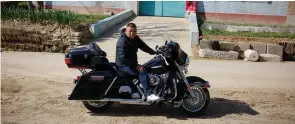  ?? (Thomas Peter/Reuters) ?? GUO QINGSHAN poses on his Harley-Davidson motorcycle in his village outside Beijing earlier this month. If prices rise, Guo said he would not contemplat­e buying another Harley.