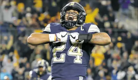  ?? Matt Freed/Post-Gazette ?? Running back James Conner celebrates a second-quarter touchdown against Virginia Tech Thursday at Heinz Field. Conner rushed for 141 yards and scored three touchdowns in the loss.