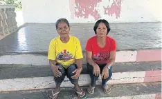  ??  ?? Corazon Vegafria and Lettie Garcisa, among the millions of Filipino women who moved to cities and abroad to find jobs, pose for a picture in Pamantinga­n village on Mindanao.