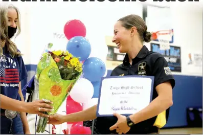  ?? Guy Mccarthy
/ Union Democrat ?? U.S. Olympics and Army sharpshoot­er Sagen Maddalena, who grew up in Groveland and finished fifth-best in the world at thetokyo Olympics in August, accepts flowers and an honorary graduate certificat­e from atenaya High School student on Friday, day one of her multi day homecoming tour in and near Groveland.