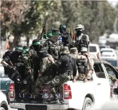  ??  ?? Palestinia­n Hamas militants take part in a military manoeuvre in Gaza City. — AFP photo