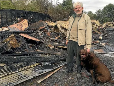  ?? PHOTO: GEORGIA FORRESTER/FAIRFAX NZ ?? John Bramley, with his dog Moose, lost 50 years of woodturnin­g work and equipment in a shed fire.