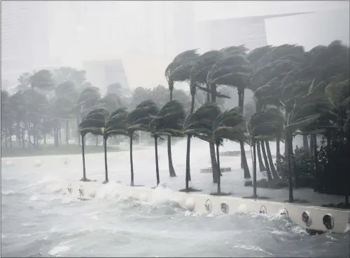  ?? PICTURE: AP PHOTO/WILFREDO LEE. ?? MIGHTY POWER: Waves crash over a seawall from Biscayne Bay as Hurricane Irma passes by in Miami yesterday, heading up the state’s west coast.