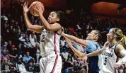  ?? Tyler Sizemore/Hearst Connecticu­t Media ?? UConn guard KK Arnold (2) pulls down a rebound in the Big East Tournament semifinal game against Marquette at Mohegan Sun Arena in Uncasville on Sunday.