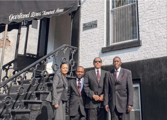  ?? Photos by James Franco / Special to the Times Union ?? The staff at Garland Bros. Funeral Home gathers Oct. 10 on Clinton Avenue in Albany prior to the services for Dary Taylor of Hudson. From left: Philippa Garland-wilcox, Rahmar Lockridge, Rodney Garland and the Rev. Thomas V. House Jr.