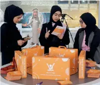  ??  ?? Students check for informatio­n of Ana-vation Robot kit that was distribute­d during the launch of the initiative in Sharjah.