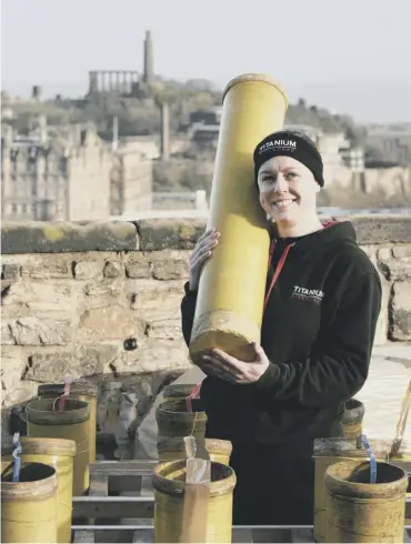  ??  ?? 0 Lynn Wiseman, pyrotechni­cian for Titanium fireworks, prepares at the castle for Hogmanay