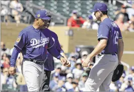  ?? DARRON CUMMINGS / AP ?? Dodgers manager Dave Roberts takes injured left-hander Scott Kazmir (right) out of Monday’s game during the second inning in Scottsdale, Ariz.