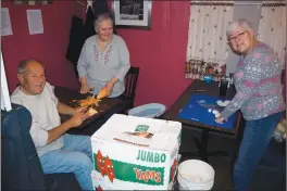  ?? ?? Helping to peel sweet potatoes were, from left, Robert Bosco of North Smithfield and Sue Angell and Paulette Sweeney of Woonsocket.