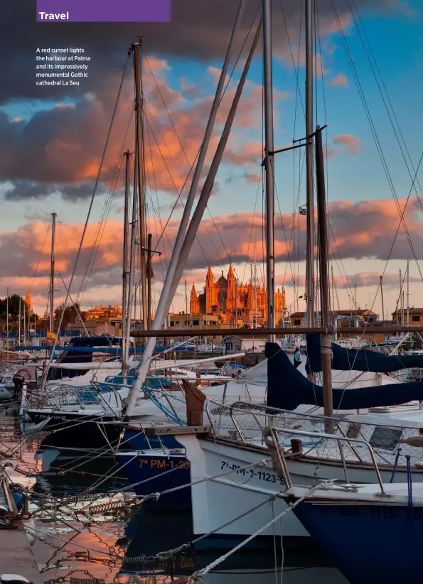  ??  ?? A red sunset lights the harbour at Palma and its impressive­ly monumental Gothic cathedral La Seu