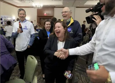  ?? Rob Ostermaier/The Virginian-Pilot via AP ?? Candidate for the 94th Congressio­nal District, Shelly Simonds, celebrates with supporters as election results begin to come in Tuesday at the Marriott in Newport News, Va. She flipped the seat from a Republican.