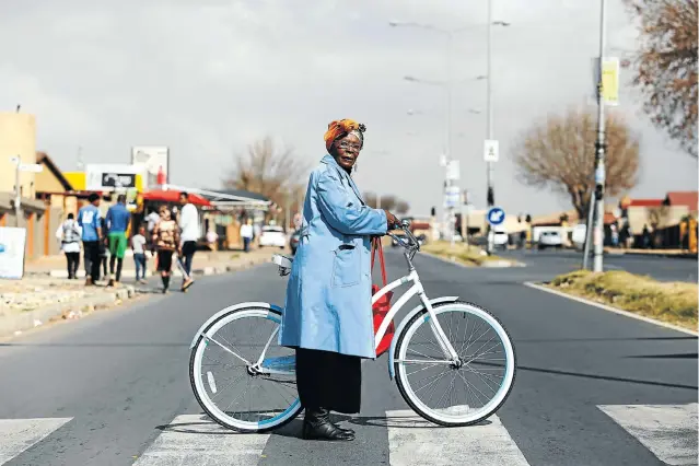  ?? Pictures: Moeletsi Mabe ?? LIFE ON WHEELS Angie Molapo, 61, runs an NGO in Soweto that trains elderly and disabled people to stay mobile with the aid of bicycles and hula hoops. She has been riding bikes since childhood.