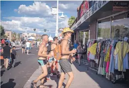  ??  ?? Route 66 Summerfest-goers visit the shops along Central Avenue on Saturday.