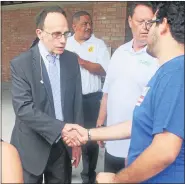  ?? MACOMB DAILY FILE PHOTO ?? In this file photo, Mayor Jim Fouts greets a resident while Councilman Pat Green and Fire Commission­er Skip McAdams look on. Fouts and Green are nowpolitic­al opponents.