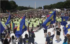  ?? THE ASSOCIATED PRESS ?? Marchers gather on the National Mall with the Washington Monument in the background during the Equality March for Unity and Pride in Washington, Sunday, June 11, 2017.