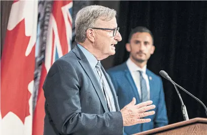  ?? CHRISTOPHE­R KATSAROV THE CANADIAN PRESS ?? On Thursday, Dr. David Williams, the province’s chief medical officer of health, said he believes it’s safe for schools to reopen under the province’s plan. Williams and Education Minister Stephen Lecce, right, addressed the province’s approach at Queen’s Park.