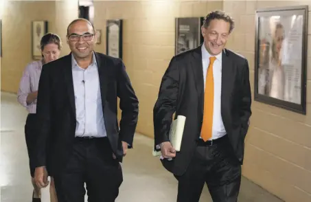  ?? Carlos Avila Gonzalez / The Chronicle ?? Giants baseball operations chief Farhan Zaidi walks to his first news conference at AT&amp;T Park with CEO Larry Baer on Nov. 7.