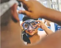  ??  ?? Zarash Khan puts on a swim mask before the swim period.