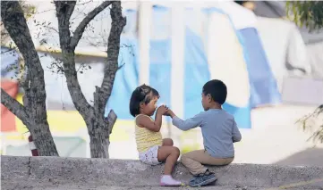  ??  ?? Children play at a camp of asylum seekers last month in Matamoros, Mexico, just south of Brownsvill­e, Texas. Increasing numbers of parents and children are crossing the border, driven by violence and poverty in Central America.