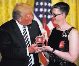  ?? Carolyn Kaster ?? The Associated Press President Donald Trump presents the National Teacher of the Year award toMandy Manning, a teacher at the Newcomer Center at Joel E. Ferris High School in Spokane, Wash., in an East Room ceremony Wednesday.