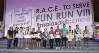  ??  ?? CSC officials pose with 3K, 5K, and 10K winners during the awards ceremony after the Fun Run.