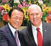  ?? FRANCK ROBICHON/AFP ?? US Vice President Mike Pence (right) and Japan’s Deputy Prime Minister Taro Aso shake hands before a meeting at Prime Minister Shinzo Abe’s official residence in Tokyo yesterday.