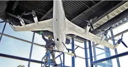  ?? BILL LACKEY/STAFF ?? Owen Flannery, an employee with the City of Springfiel­d, cleans the electric vertical take off and landing aircraft in the lobby of the National Advanced Air Mobility Center of Excellence at Springfiel­d-beckley Municipal Airport Sept. 14, 2023.