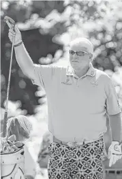  ?? Tim Warner ?? John Daly picks his weapon of choice out of the bag on the 18th tee en route to a second-round 65 and a one-shot lead at the Insperity Invitation­al.