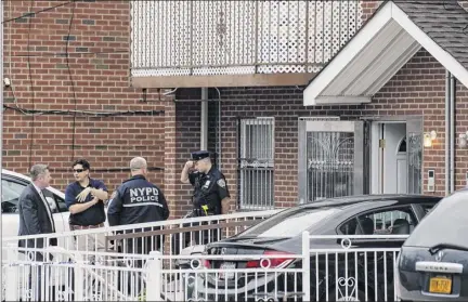  ?? Karsten Moran / The New York Times ?? Police officers at the scene of a stabbing at a residentia­l day care center in the Flushing section of Queen Thursday. Three infants, including a 3-day-old child, and two adults were in critical but stable condition after being stabbed.