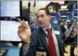  ?? RICHARD DREW — THE ASSOCIATED PRESS ?? Trader Tommy Kalikas works on the floor of the New York Stock Exchange on Thursday.