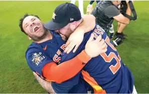  ?? (AP photo/David J. Phillip, File) ?? Houston Astros’ Jose Altuve, left, embraces relief pitcher Ryan Pressly Nov. 5, 2022, as they celebrate their World Series win against the Philadelph­ia Phillies in Game 6. Altuve and the Astros get another opportunit­y to celebrate the franchise’s second World Series championsh­ip on March 30 when they host Tim Anderson and the Chicago White Sox on opening day.