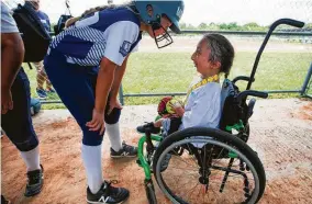  ??  ?? Emma Blount meets with her best friend, Nalah, during the home-run derby. The girls met in the first days of kindergart­en at Big Colony Elementary School.