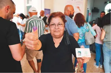  ?? AFP ?? ■
A Lebanese woman shows her ink-stained finger at a polling station after voting for the parliament­ary election in the town of Jounieh, north of the capital Beirut, yesterday.