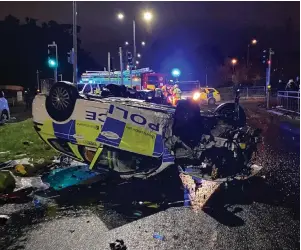  ?? Pictures: Martin Garrow ?? A police car ended up on its roof