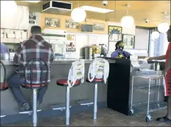  ??  ?? Return to normalcy: Customers enjoy dine-in and take-out service at a Waffle House in Brookhaven, Ga., after the state reopened last month.