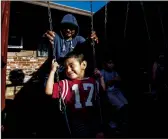  ?? GINA FERAZZI/LOS ANGELES TIMES ?? Farmworker Jose Luis Hernandez spends time with his sons Carlos, 2, Jose, 6, and Angel, 9, outside their apartment on Oct. 14 in Stockton.