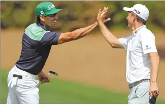  ?? Associated Press photo ?? Rafael Cabrera Bello, left, and Justin Rose celebrate their birdies on 10 during the second round of the Masters golf tournament at Augusta National Golf Club in Augusta, Ga., Friday.