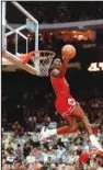  ?? The Associated Press ?? HIGH-FLYING: Chicago Bulls’ Michael Jordan dunks during the slam-dunk competitio­n of the NBA All-Star weekend in Chicago on Feb. 6, 1988. Jordan left the old Chicago Stadium that night with the trophy.