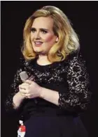  ??  ?? On a winning streak: Adele accepting the Album of the Year award at the Brit music awards in London. — AFP