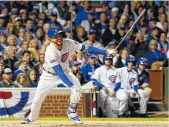  ?? THE ASSOCIATED PRESS ?? Chicago Cubs third baseman Kris Bryant hits an RBI single during the first inning of Game 6 of the National League baseball championsh­ip series against the Los Angeles Dodgers in Chicago. The young Cubs take on the Cleveland Indians tonight in Game 1 of the World Series in Cleveland.