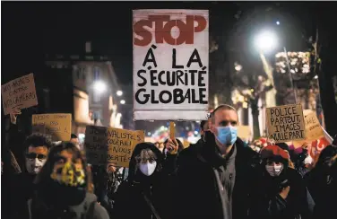  ?? Lionel Bonaventur­e / AFP via Getty Images ?? Protesters in Toulouse rally Thursday against a proposed law criticized as shielding police brutality.