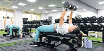  ?? REUTERS ?? People exercise in a gym as lockdown restrictio­ns are eased amidst the pandemic at Maindy Leisure Centre in Cardiff, Wales, Britain on Monday.