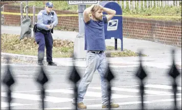  ?? SATHI SOMA / VIA ASSOCIATED PRESS ?? Edgar Maddison Welch surrenders Sunday to Washington, D.C., police after he fired an assault rifle inside a pizza restaurant.