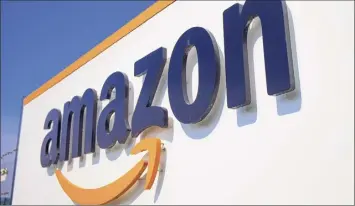  ?? Michel Spingler / AP ?? Amazon said Thursday that nearly 20,000 of its workers have tested positive or been presumed positive for the virus that causes COVID-19.