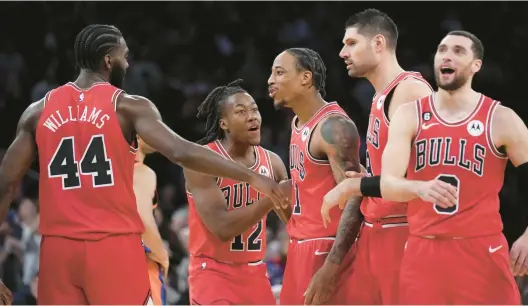  ?? SETH WENIG/AP ?? Bulls forward DeMar DeRozan, center, celebrates with teammates after hitting the winning basket during the closing seconds against the Knicks on Friday.