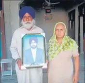  ??  ?? Parents of victim Gurjeet Singh with his picture and (right) family members of Krishan Bhagwan Singh.