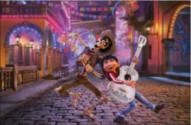  ?? DISNEY-PIXAR VIA AP ?? In this image released by Disney-Pixar, character Hector, voiced by Gael Garcia Bernal, left, and Miguel, voiced by Anthony Gonzalez, appear in a scene from the animated film, “Coco.”