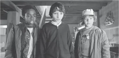  ?? PHOTOS COURTESY OF NETFLIX ?? Pals Lucas (Caleb McLaughlin, left), Mike (Finn Wolfhard) and Dustin (Gaten Matarazzo) uncover a larger, more sinister conspiracy in their not-so-ordinary small town.