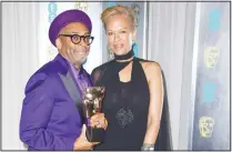  ??  ?? Spike Lee (left), with his Best Adapted Screenplay award for and producer Tonya Lewis Lee pose. (AP)